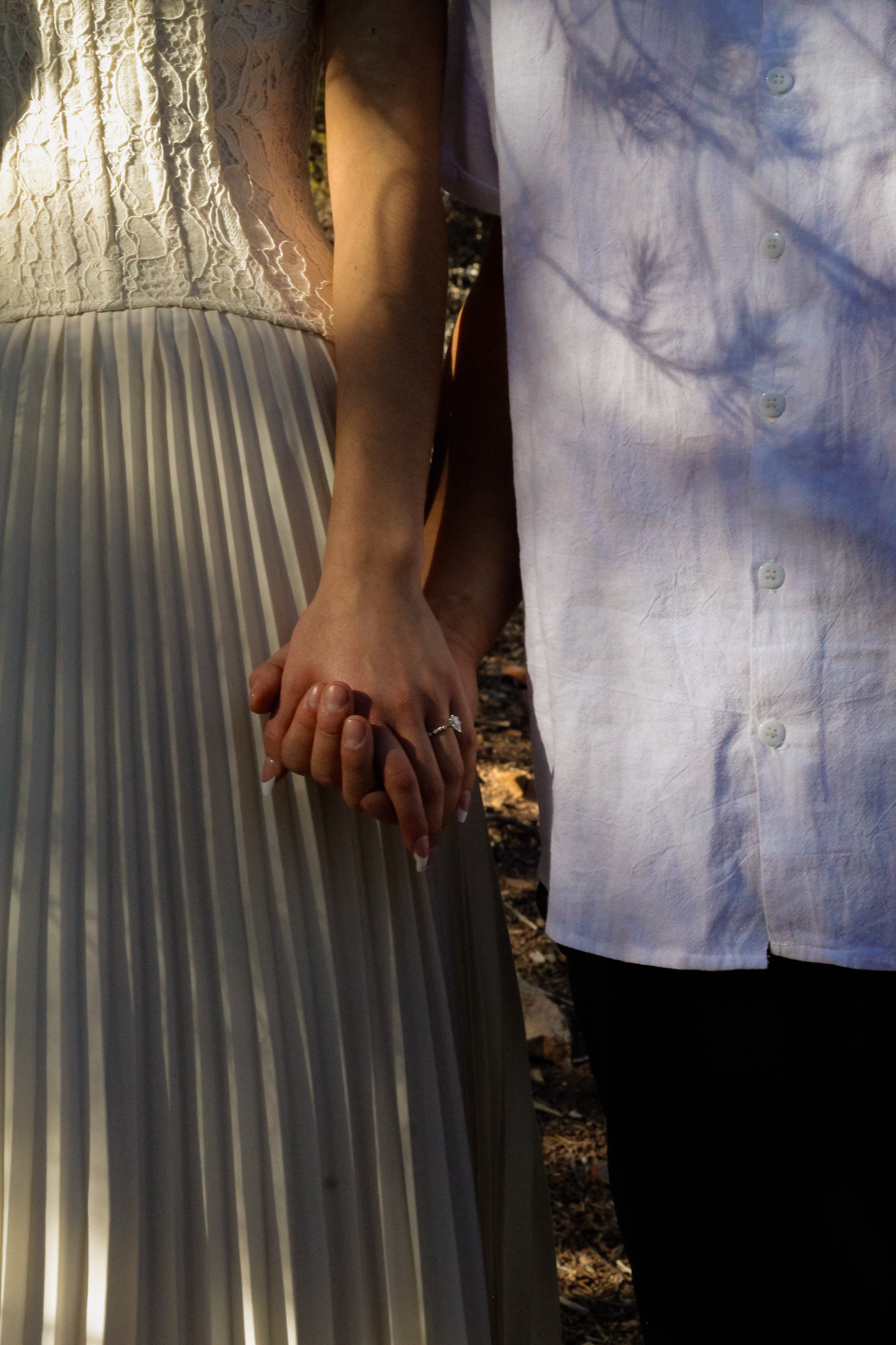Drazy and Lupe holding hands in warm afternoon light