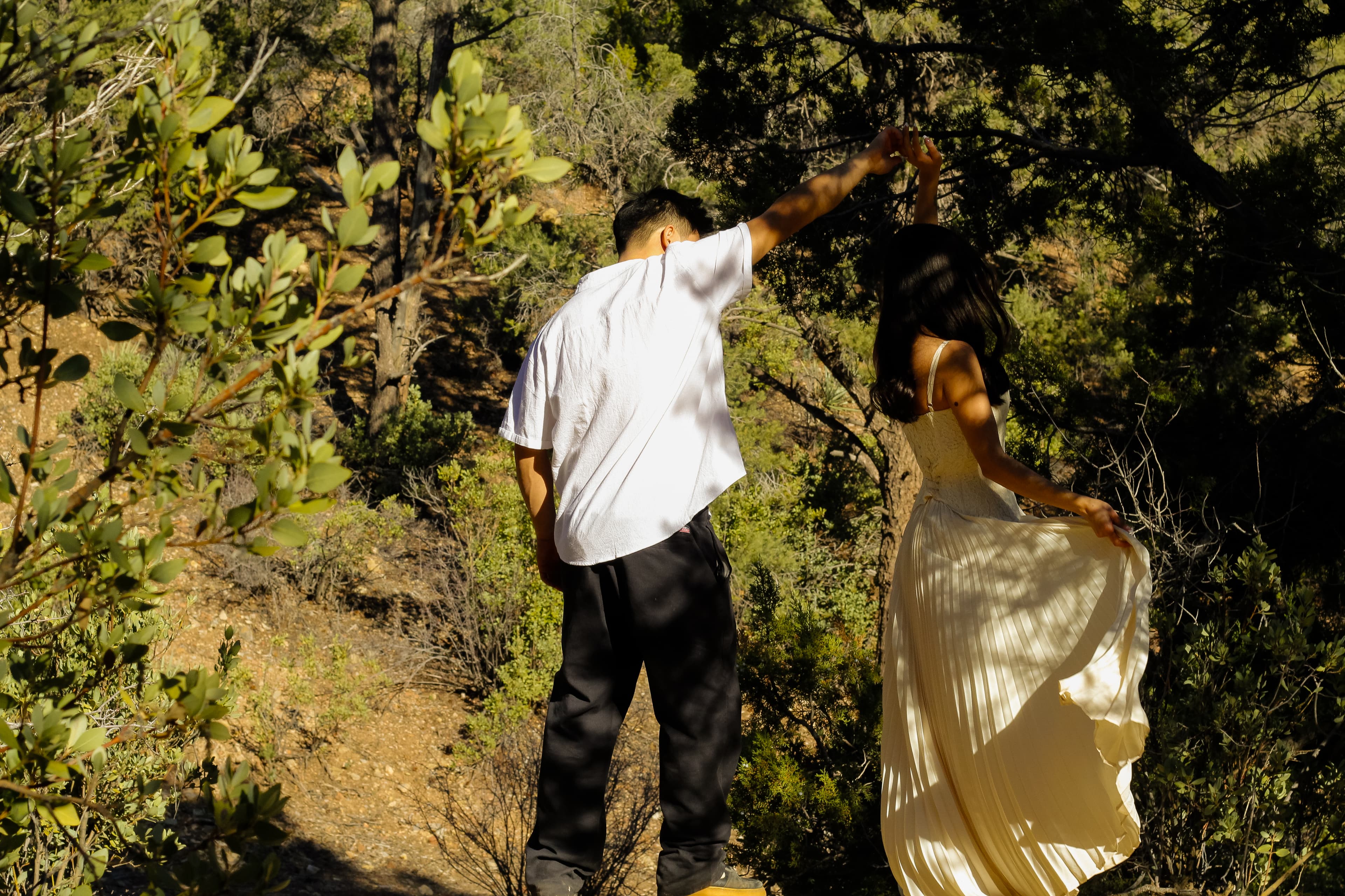 Drazy and Lupe walking through desert trees